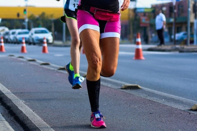female runner wearing compression calf sleeves