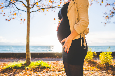 Pregnant woman standing in a park