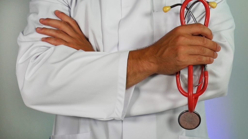 Doctor standing holding his stethoscope